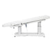 Tranquility 4-Motors Electric Medical Spa Treatment Table Side View Of White Variant Fully Reclined Chair With Raised Leg Section And Remote Control On White Background