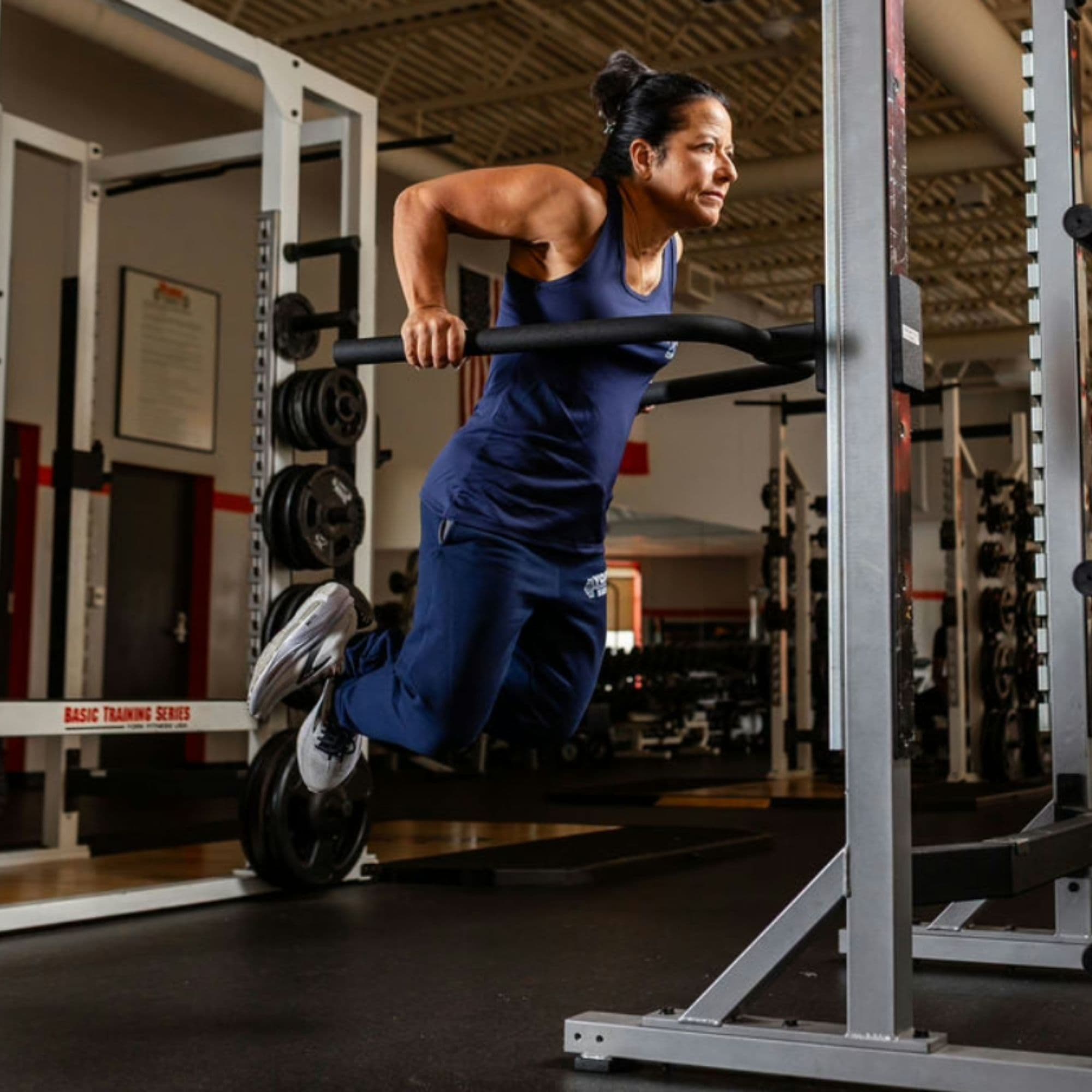 York Barbell STS Dip Attachment With A Front Angle View Of A Woman Performing The Upper-Body Training On Gym Setting