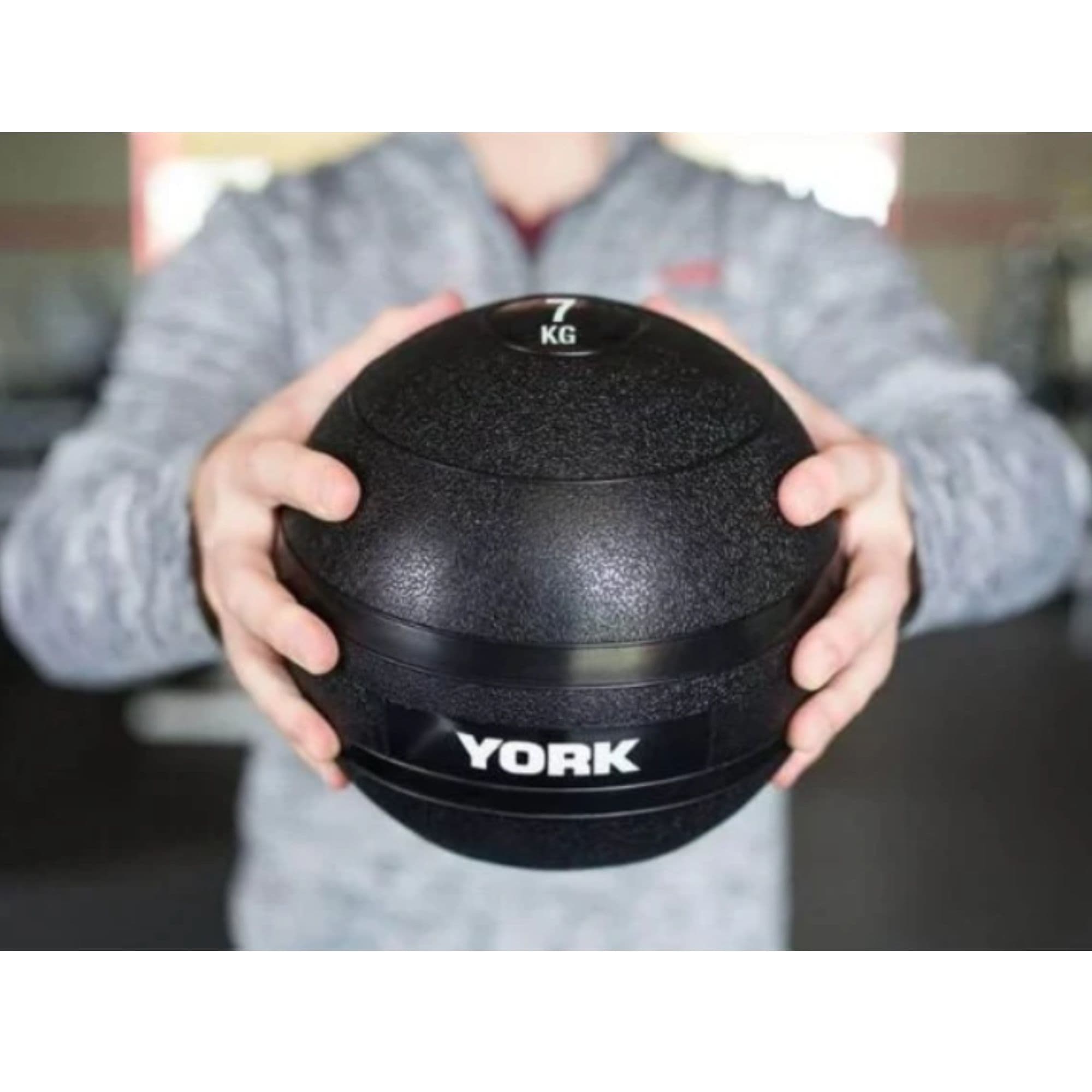 York Barbell Slam Ball Set Detailed View Of 7KG Held In Hands