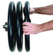 York Steel ISO-GRIP 300lb Olympic Set With Hands Loading Weight Plates Onto The Bar On White Background